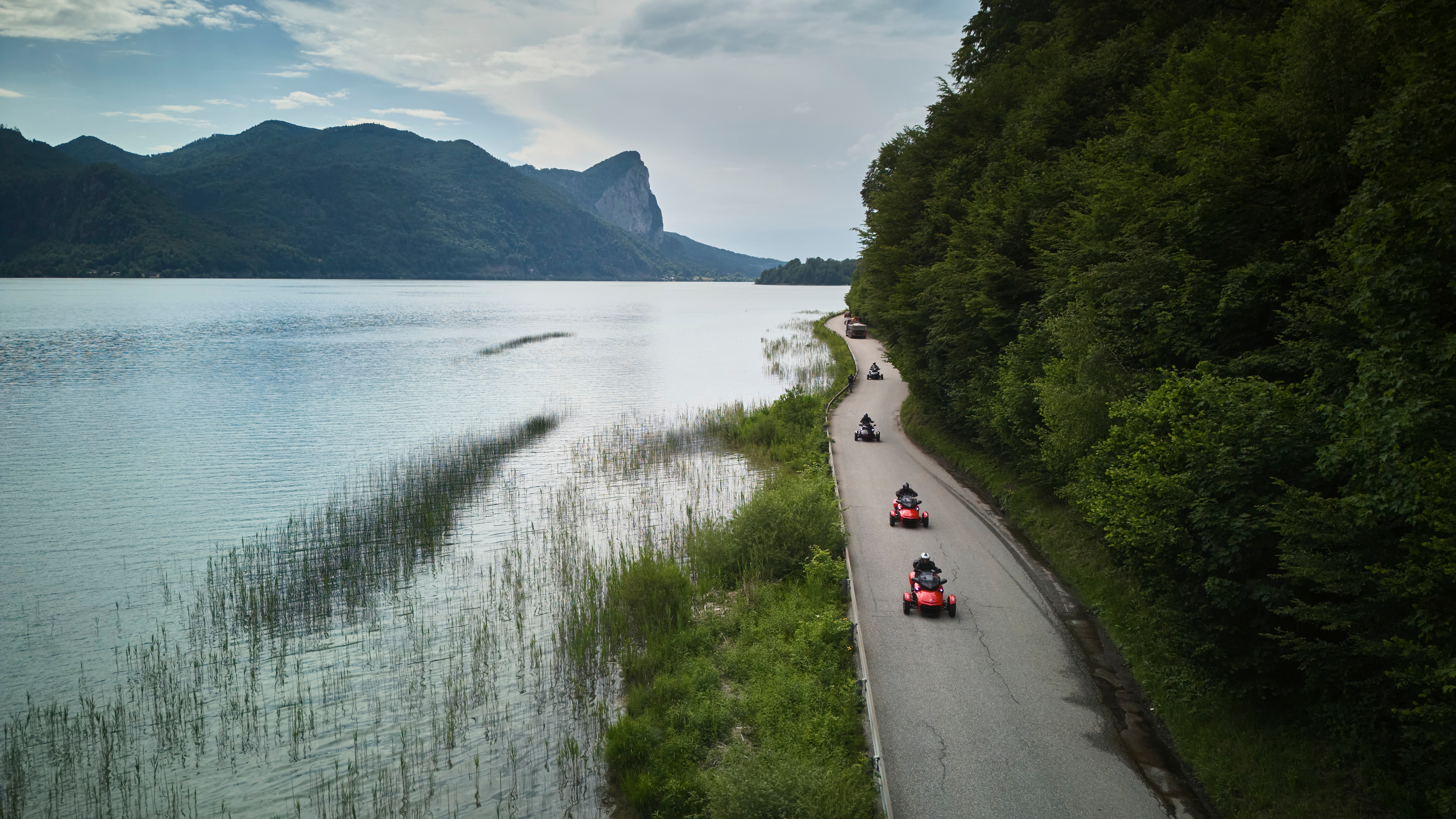 Several Can-Am Spyders riding along the lake